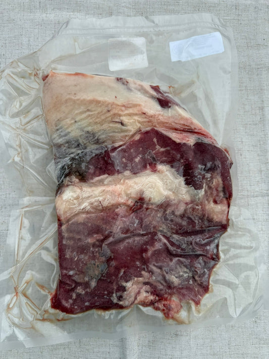 Raw meat on a clear plastic bag with a white background